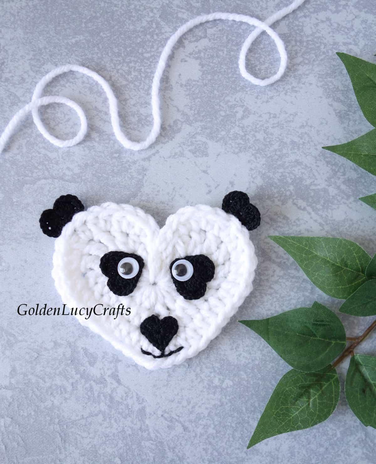 Crochet heart-shaped panda applique.