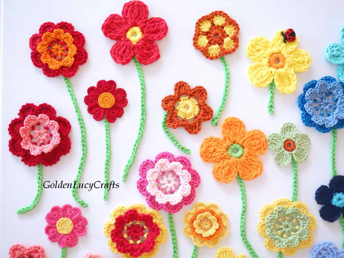 Crocheted flowers on canvas wall art, close up picture.