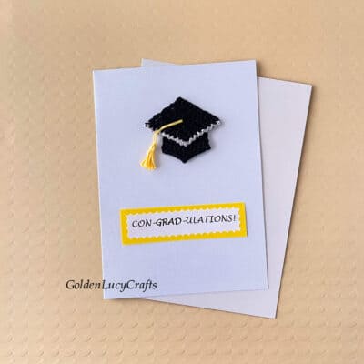 Handmade card with crochet graduation cap on it and note saying Congradulations.