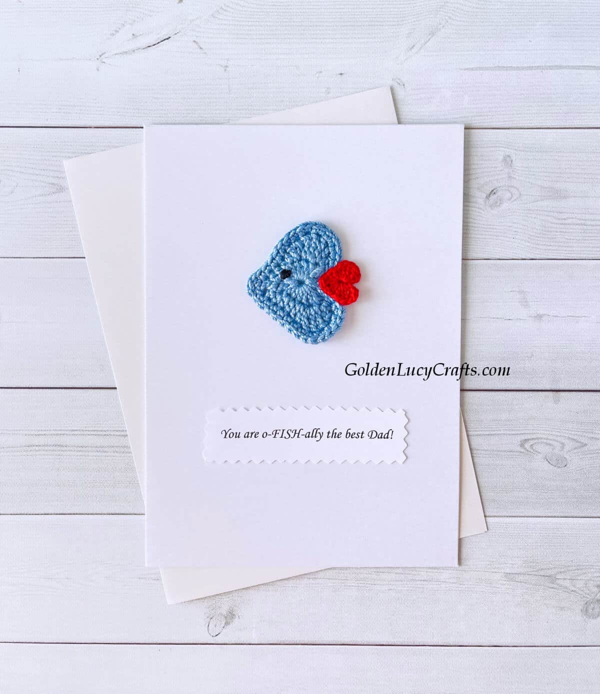 Crochet heart-shaped fish on a white card with the text "You are ofishally the best dad!"