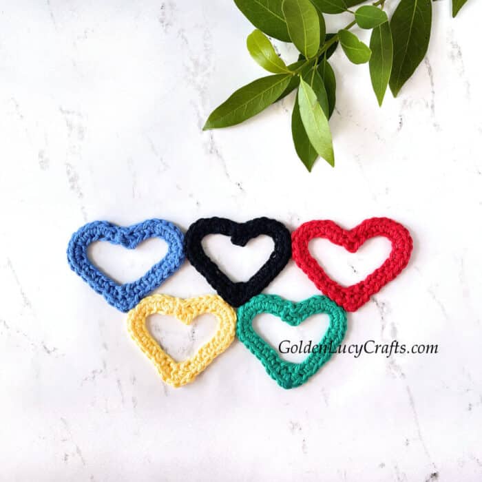 Crocheted heart-shaped Olympic rings applique.