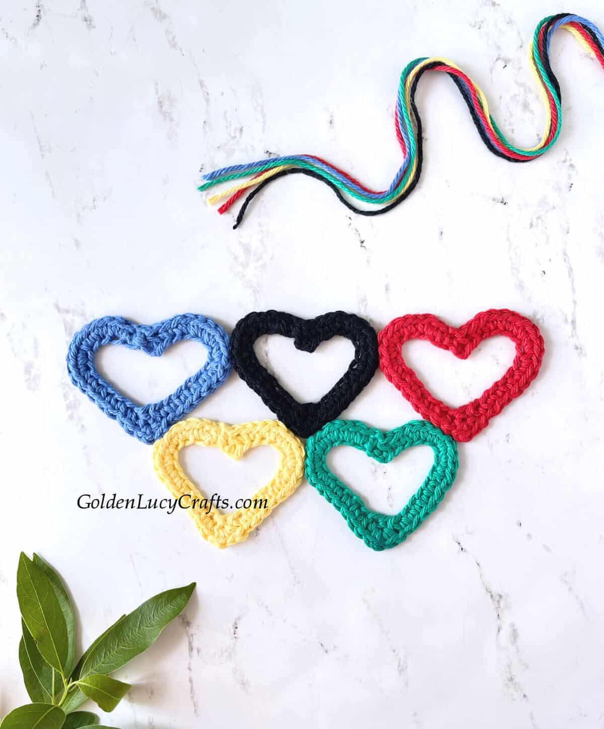 Crocheted heart-shaped Olympic rings applique.