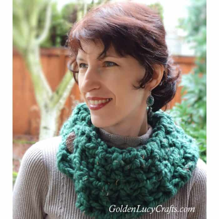 Model dressed in green cowl.