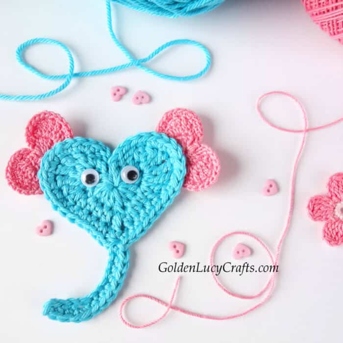 Crochet heart elephant applique in aqua with pink ears, close up picture.