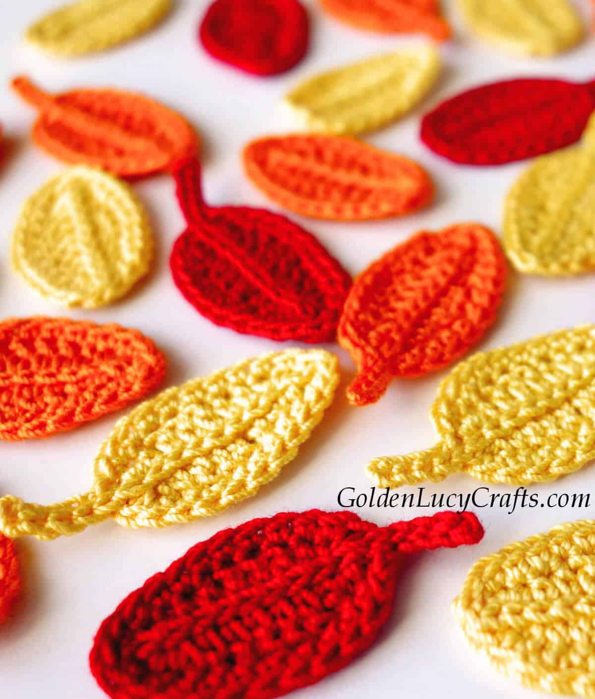 Crochet leaves in red, yellow and orange colors.