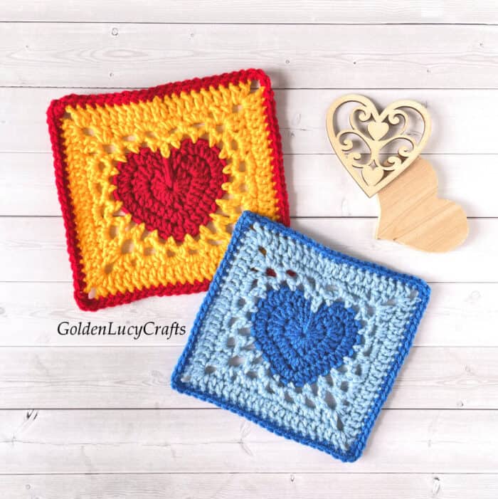 Two crocheted granny squares with heart in the middle of each.