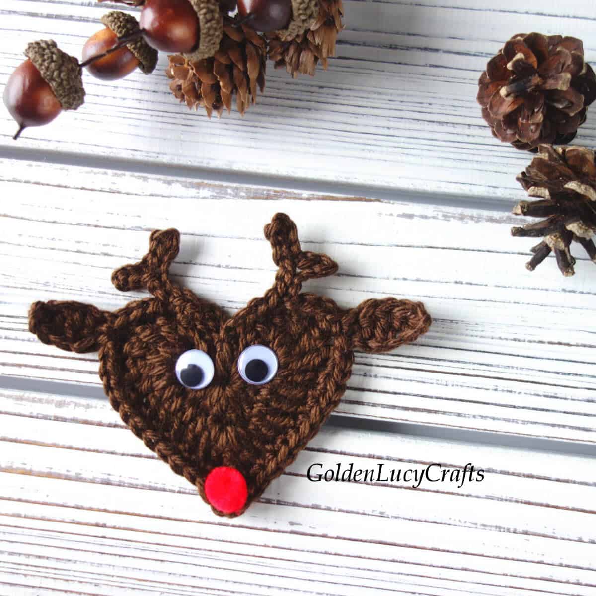 Crochet heart-shaped reindeer applique.