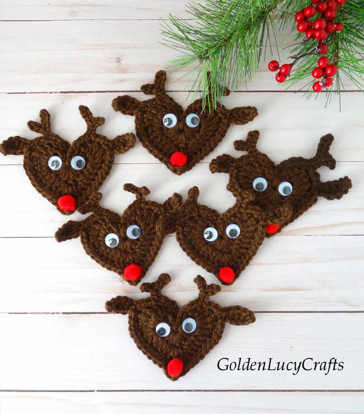 Six crocheted reindeer appliques.