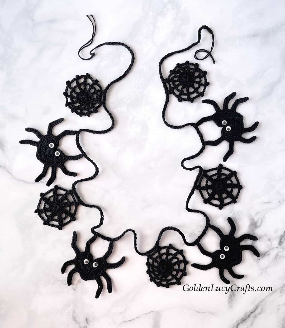 Crochet Halloween garland spiders and spider webs.