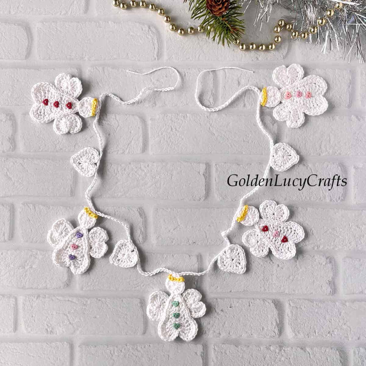 Crocheted Christmas garland with angels and hearts.