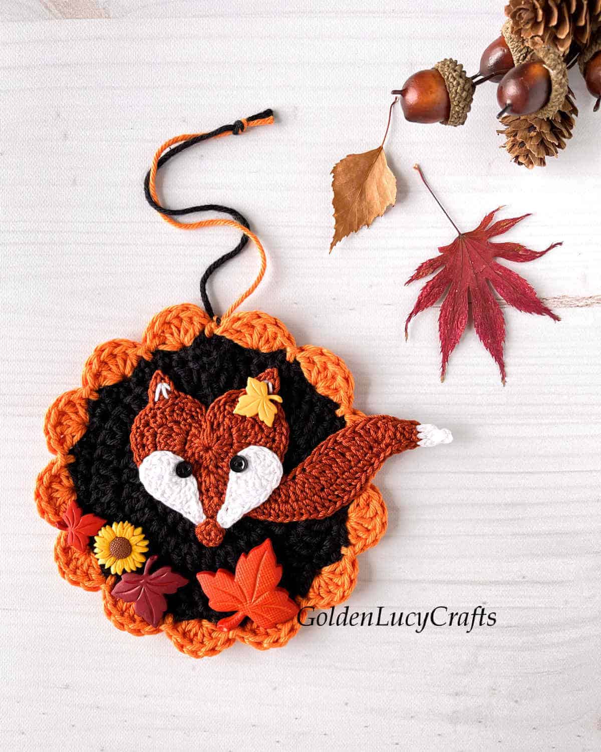Crochet ornament with fox and craft buttons.