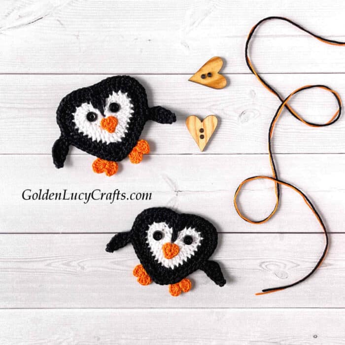 Two crocheted penguin appliques.