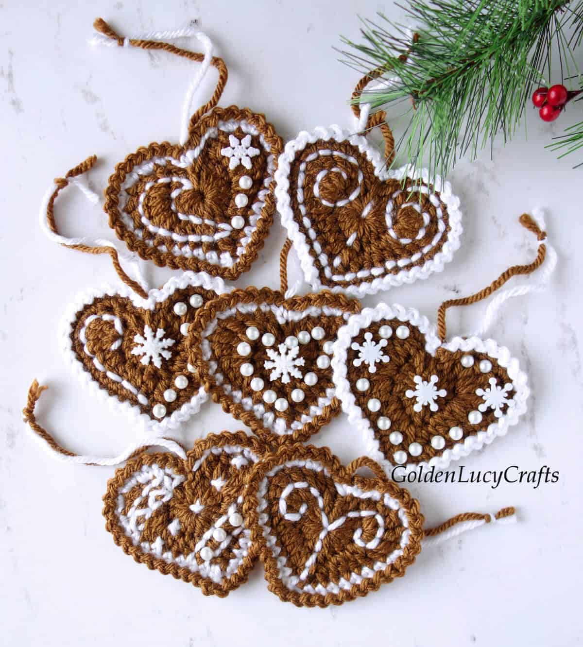 Six crocheted gingerbread hearts Christmas ornaments.