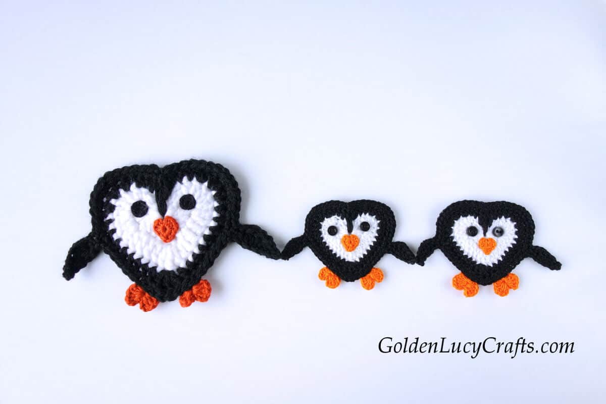 Three crochet penguin appliques.