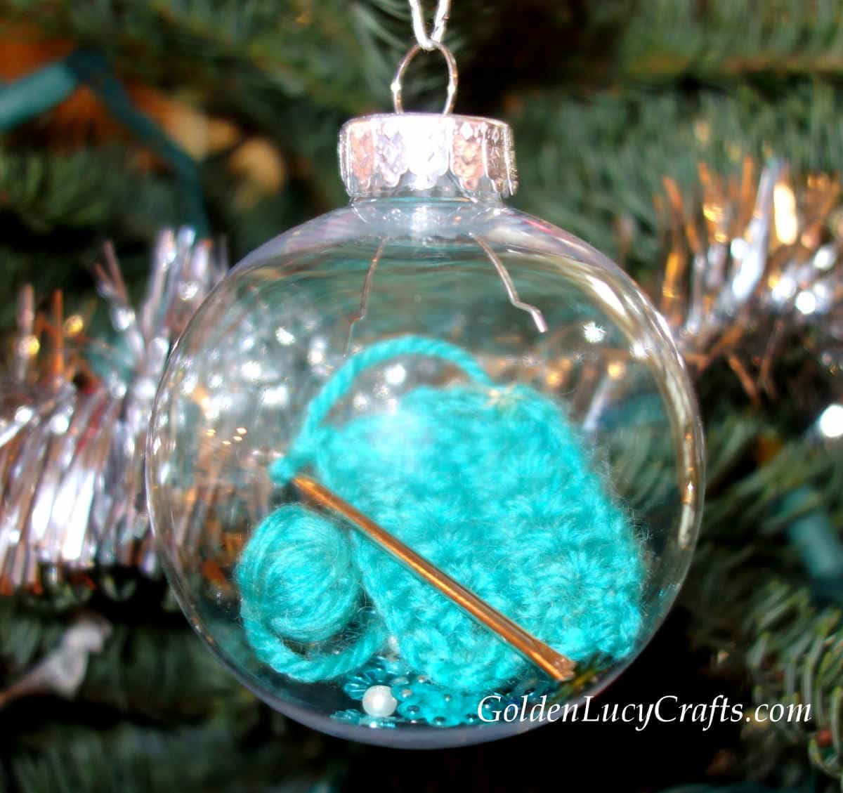 Crochet themed clear ball ornament on the Christmas tree.
