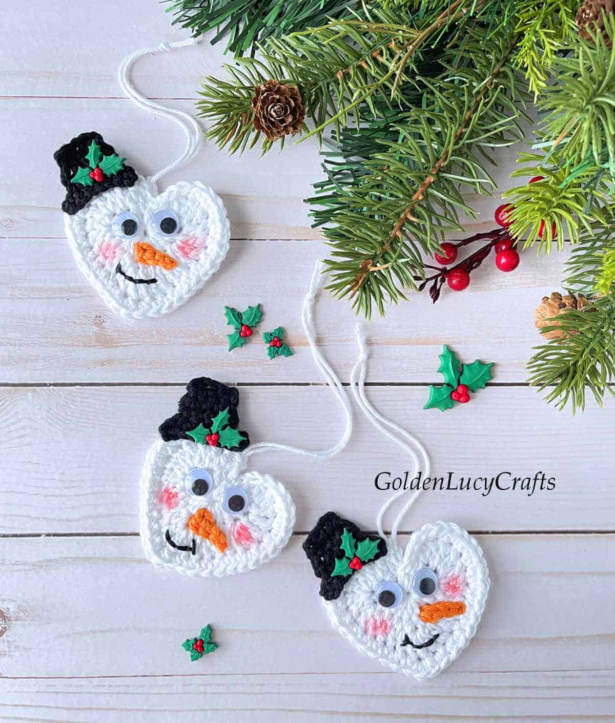 Three crocheted snowman ornaments.
