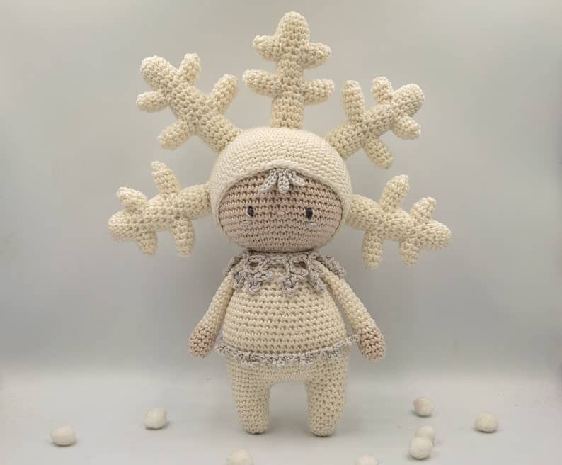 Crocheted snowflake toy amigurumi.