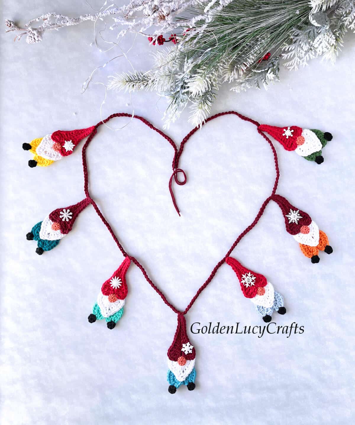 Heart shape made from crochet gnome garland.