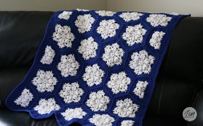 Crocheted blue with white snowflakes blanket.