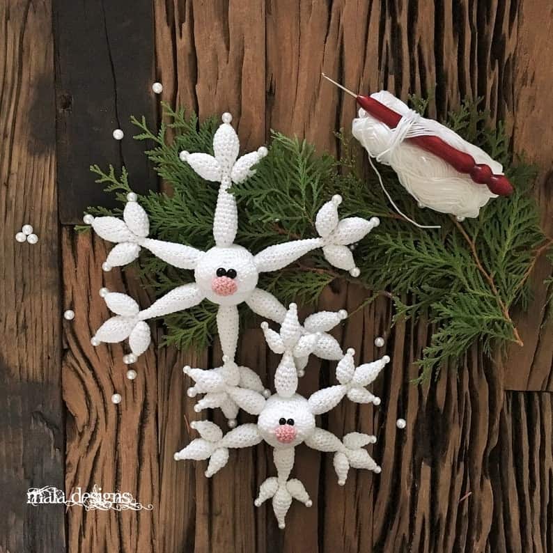 Two crocheted snowflake toys amigurumi.