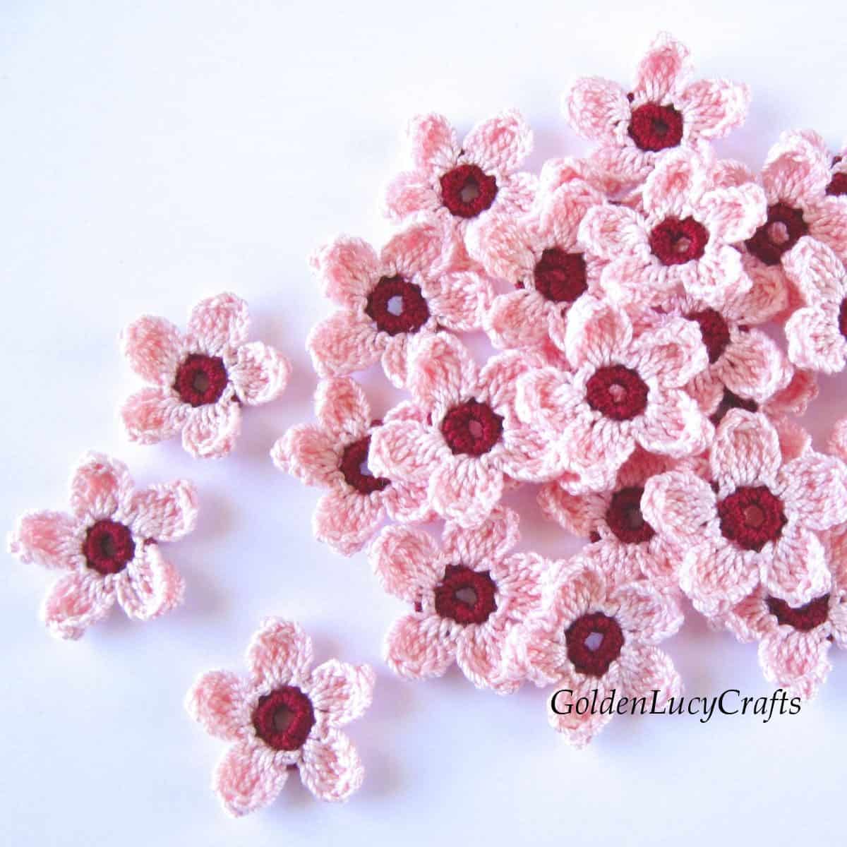 Bunch of crocheted cherry blossoms.