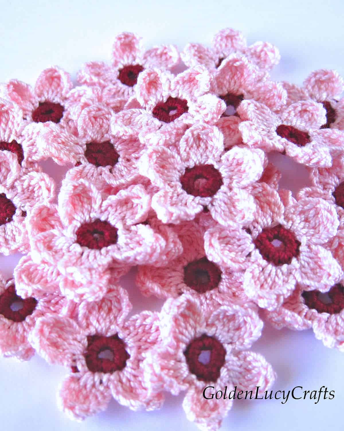 Bunch of crochet cherry blossom flowers.