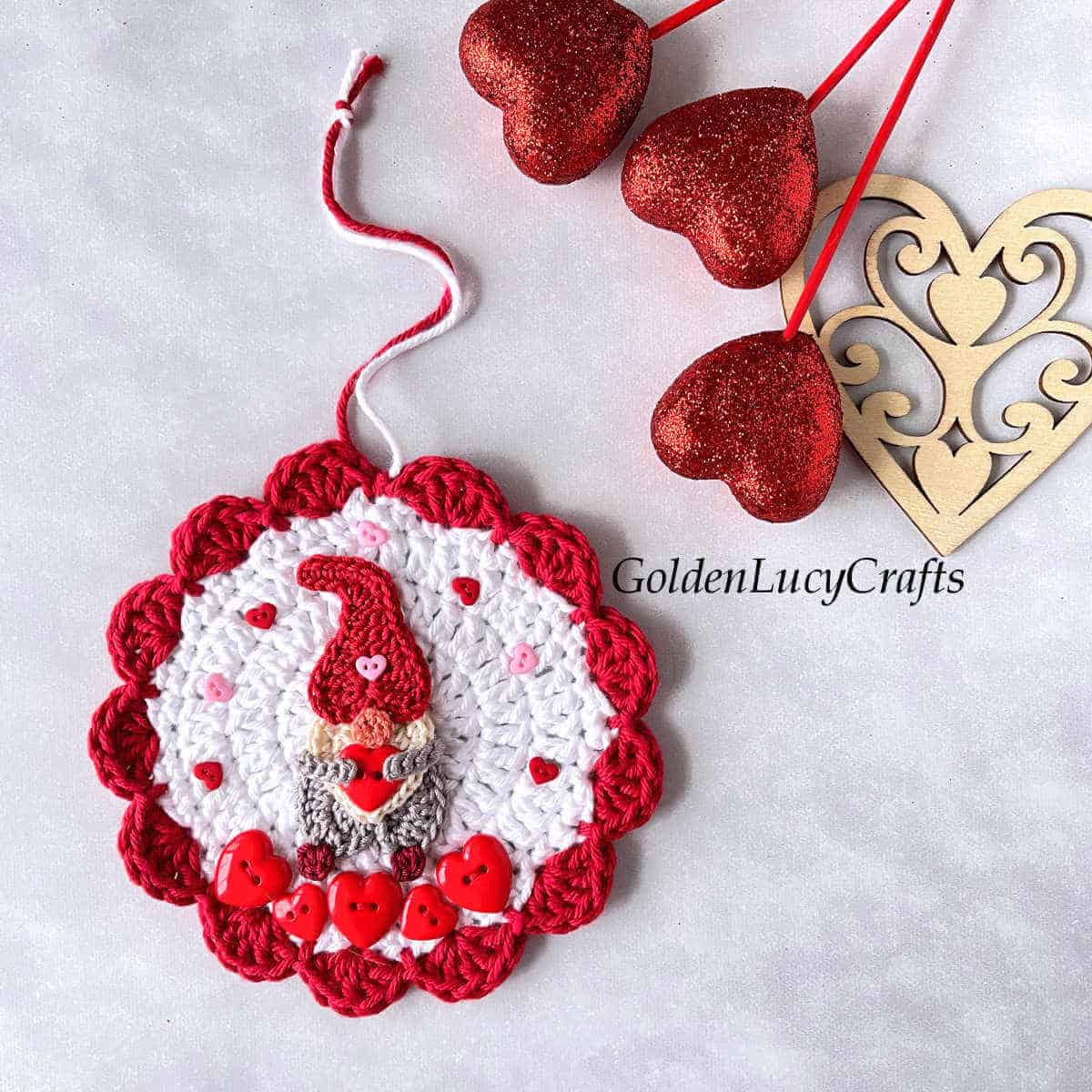 Crochet ornament with heart gnome on it.