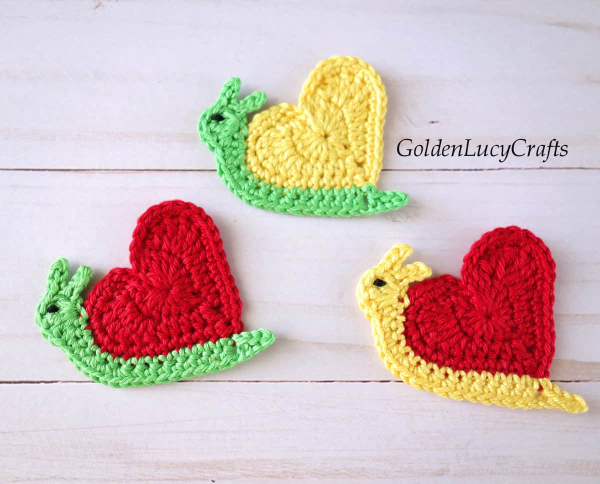 Three crochet snail appliques.