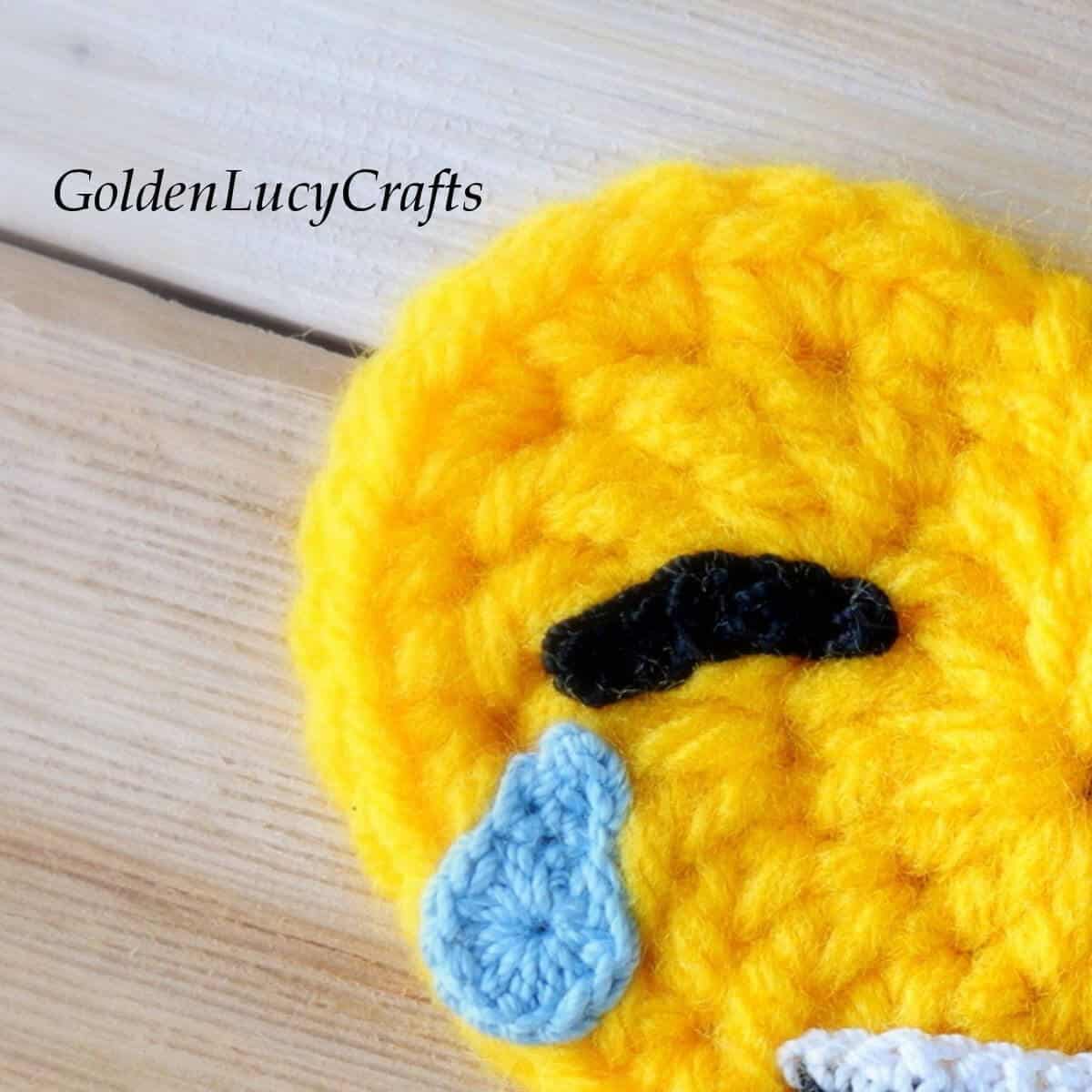 Crochet emoji close up picture - eye and tear.