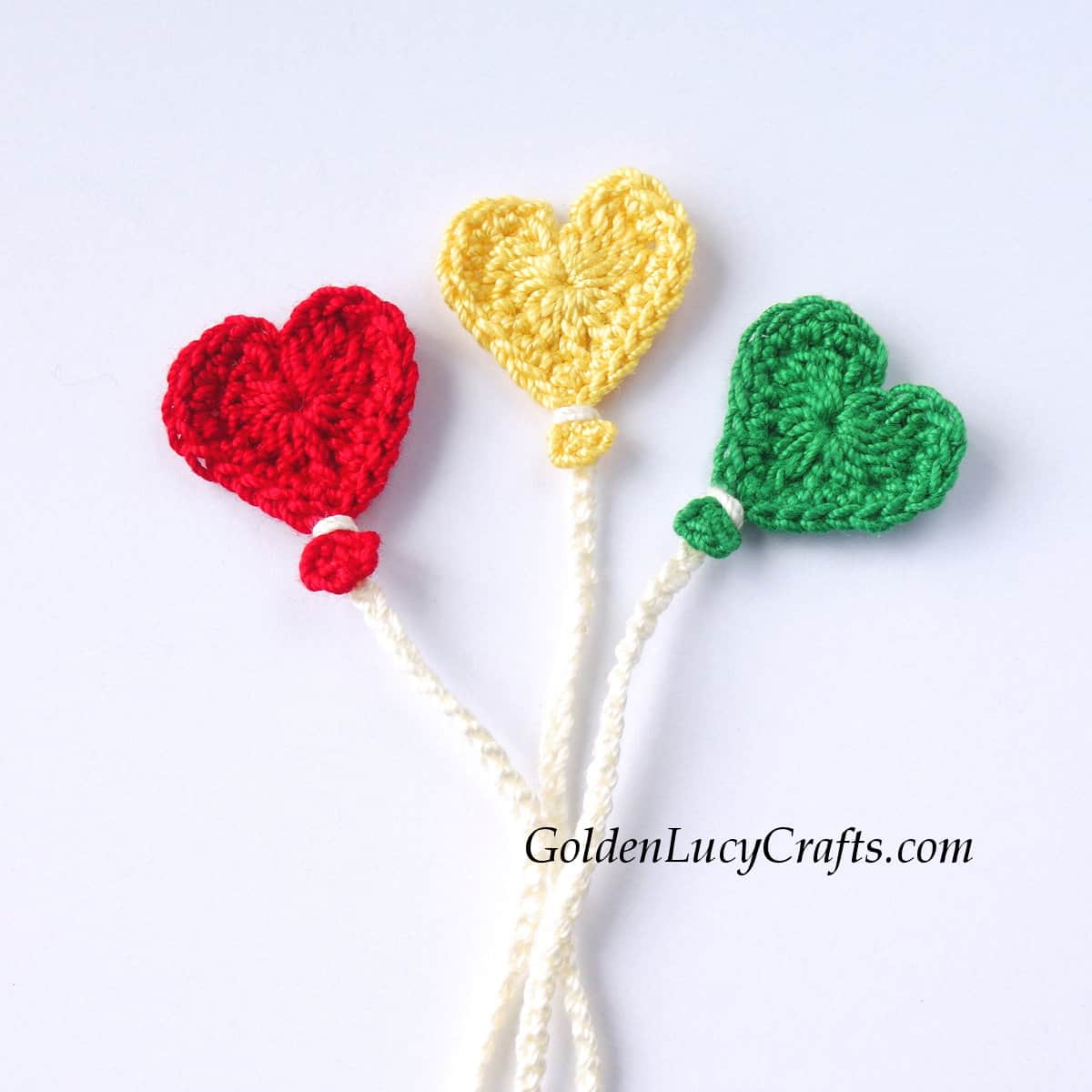 Three crochet heart-shaped balloons.