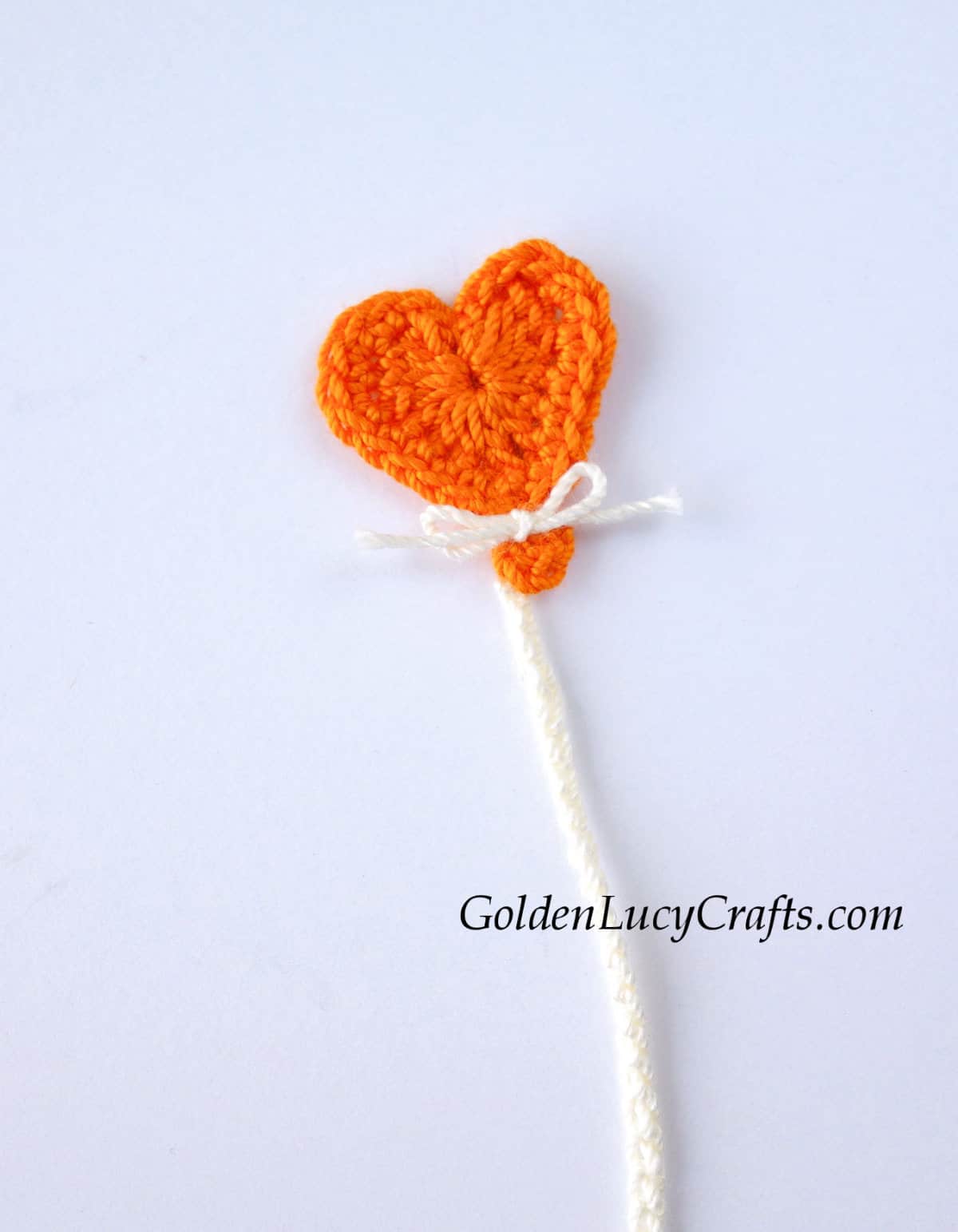 Crochet orange heart balloon applique.