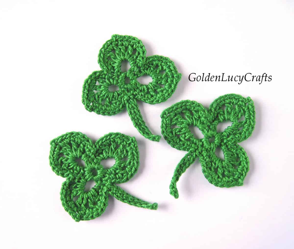 Three crocheted shamrock leaves.