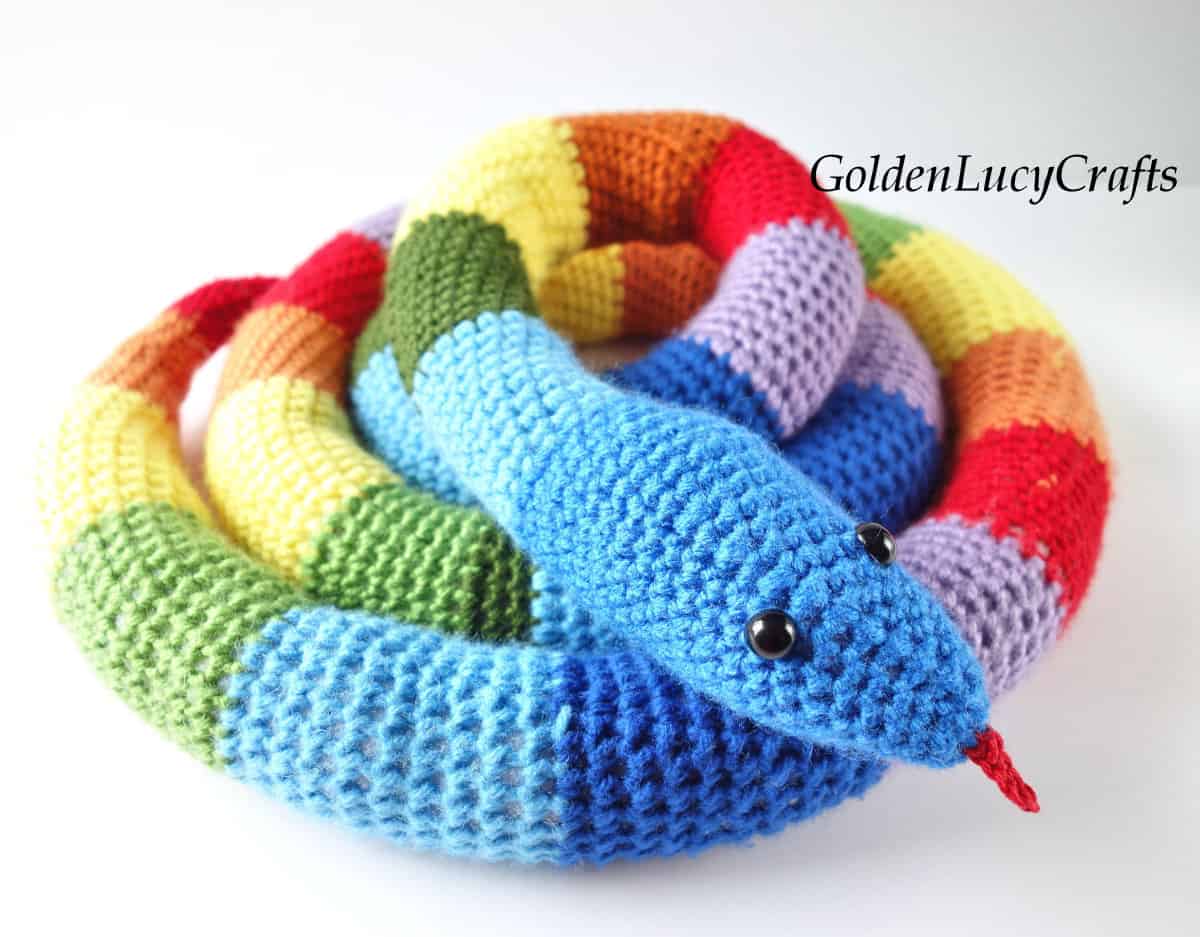 Crochet snake toy in rainbow colors.