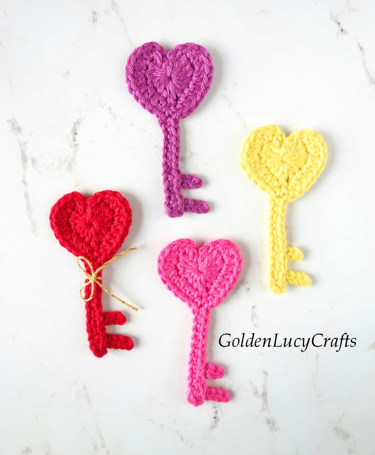 Four crochet heart key appliques.