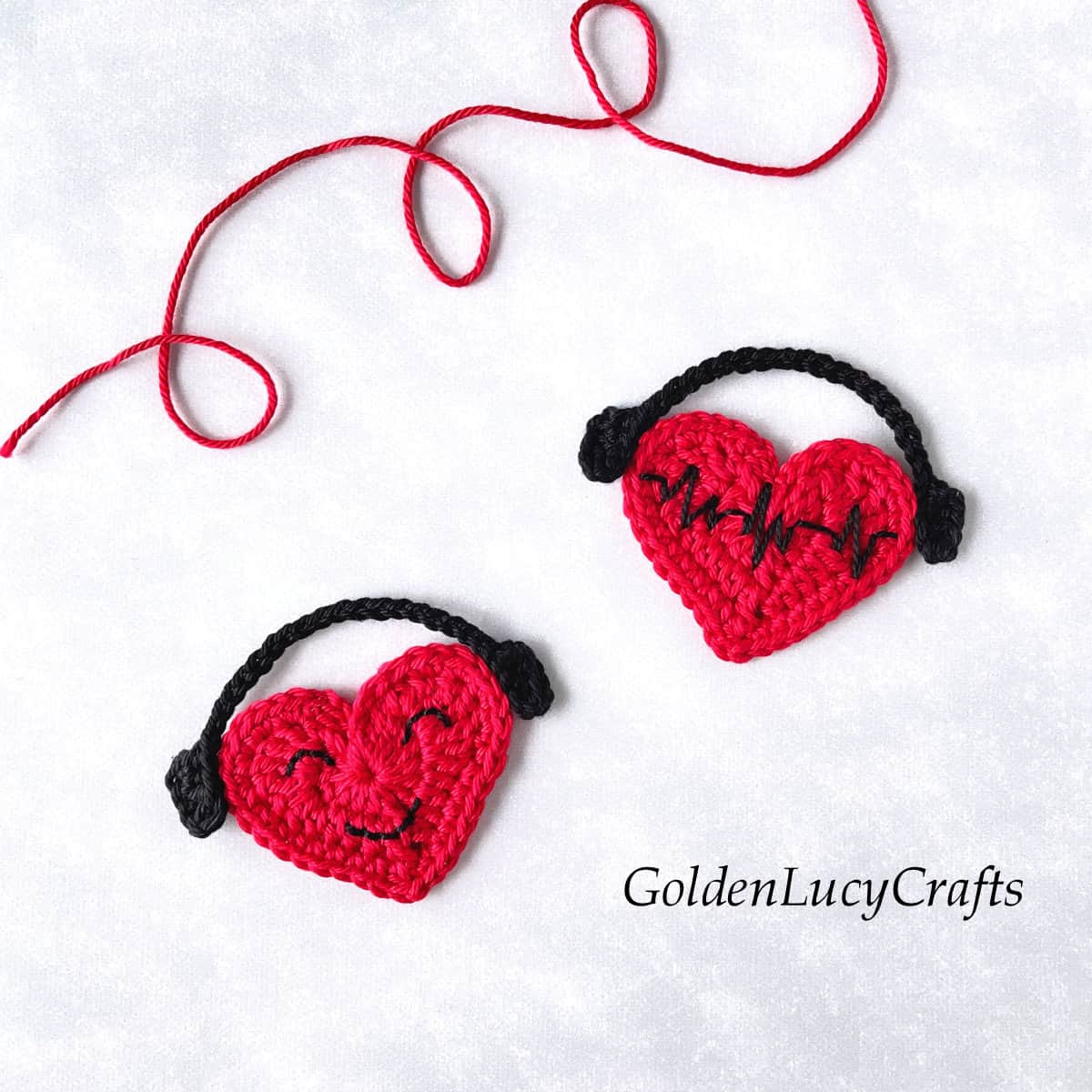 Crochet appliques two red hearts with headphones.