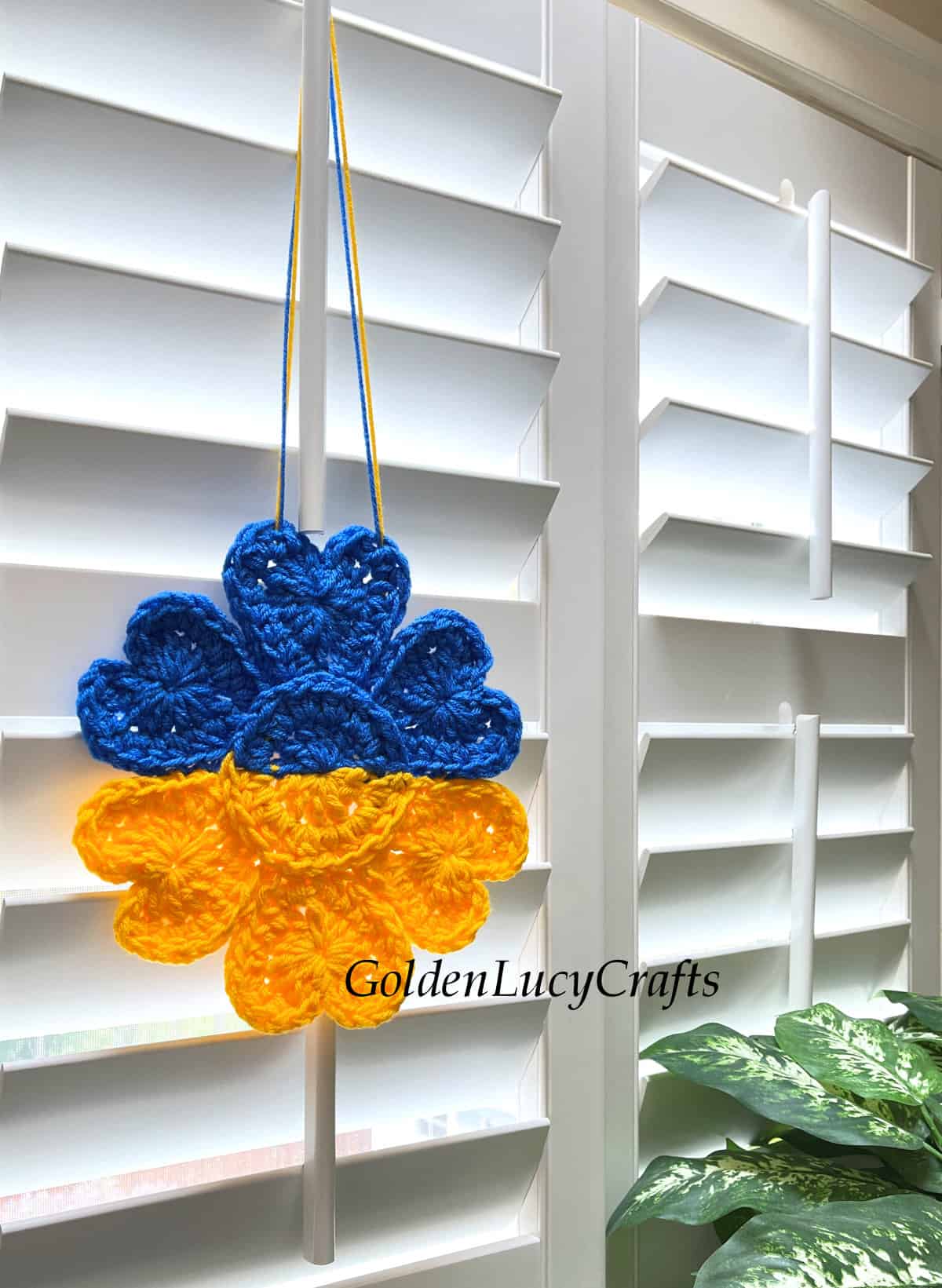 Crochet Ukrainian sunflower hanging on the window.