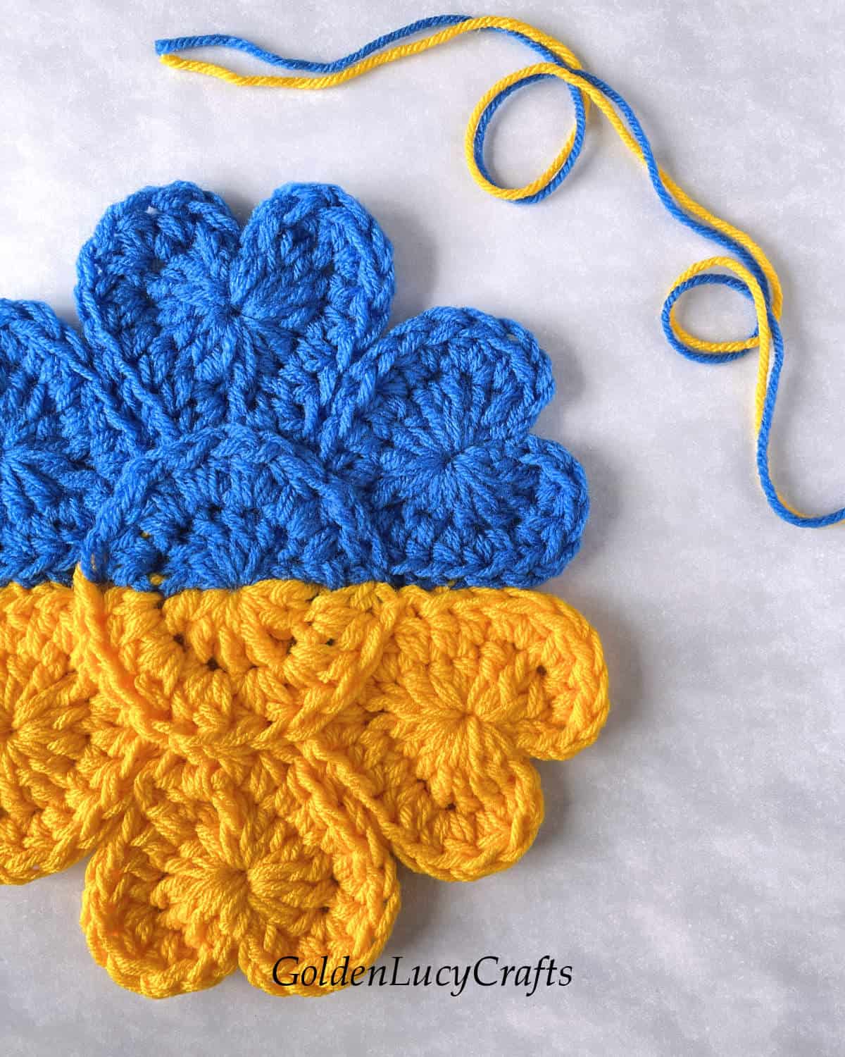 Yellow blue crochet flower close up picture.