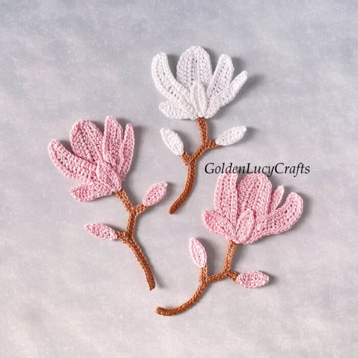 Three crochet magnolia appliques.
