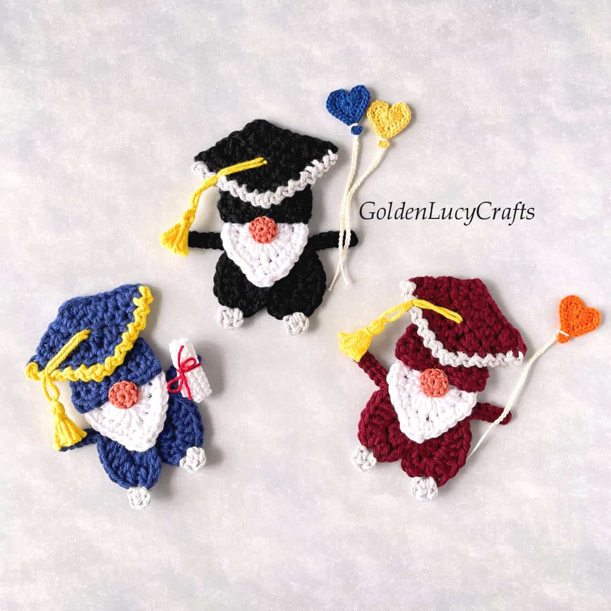 Three crocheted graduation gnomes.