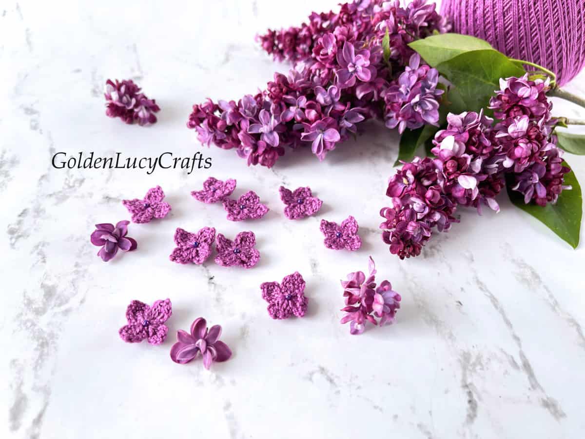 Crocheted and real lilac flowers.