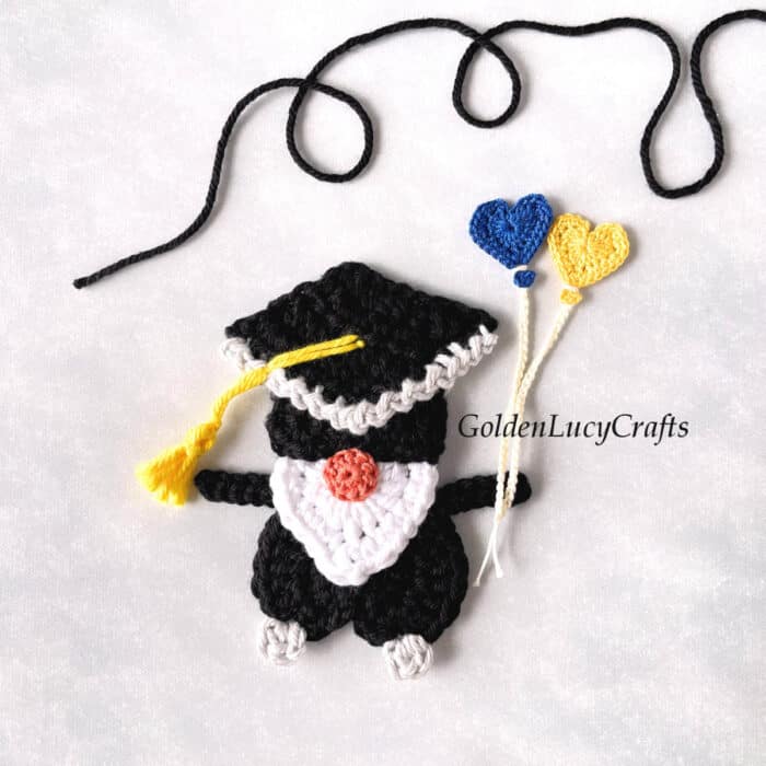 Crochet graduation gnome with heart balloons applique.