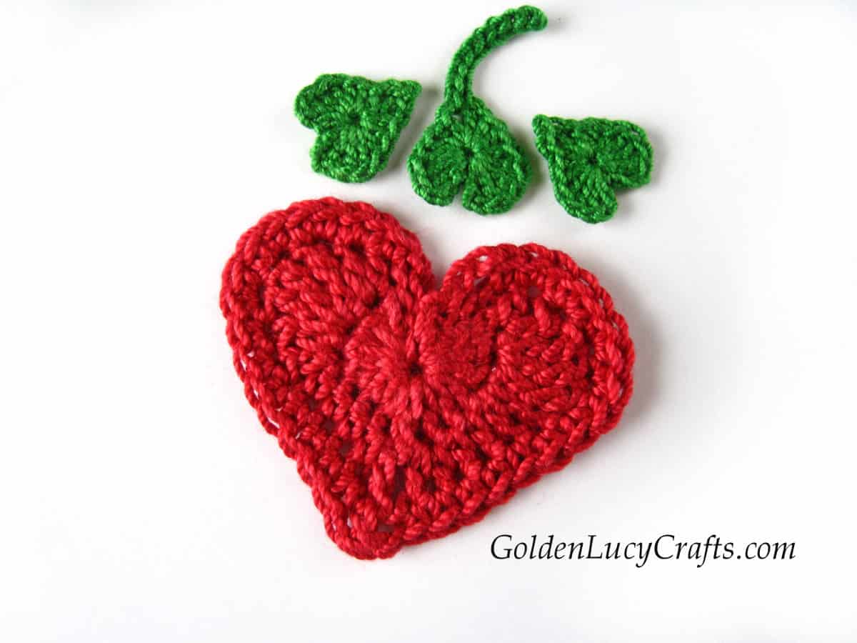Parts of crocheted heart strawberry applique.