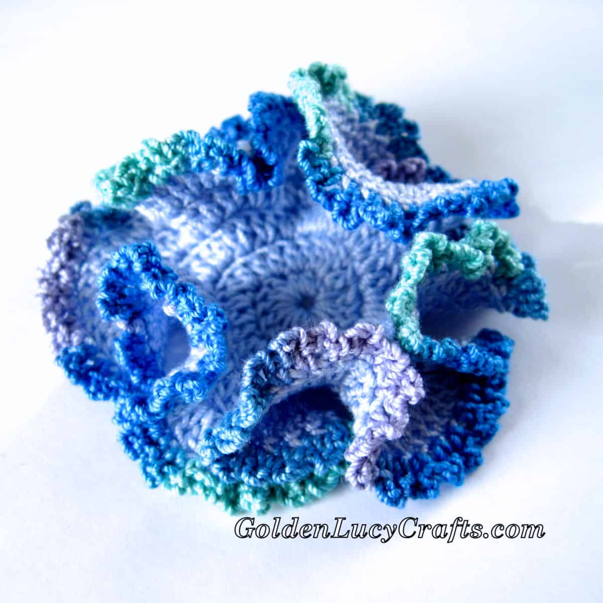 Crochet hyperbolic coral in variegated blue colors.