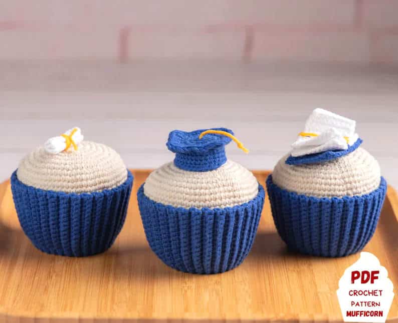 Three crochet cupcakes made in graduation theme.