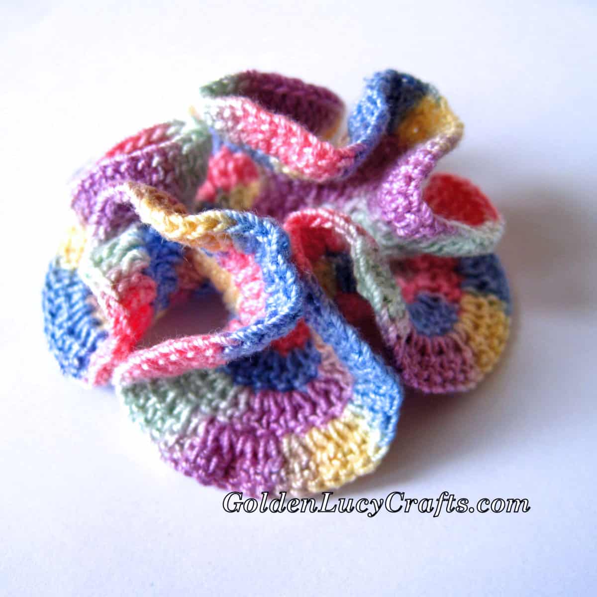 Crochet hyperbolic coral made with multi-color yarn.