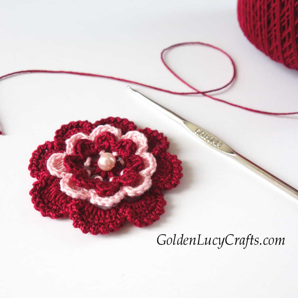 Crocheted dark red flower.