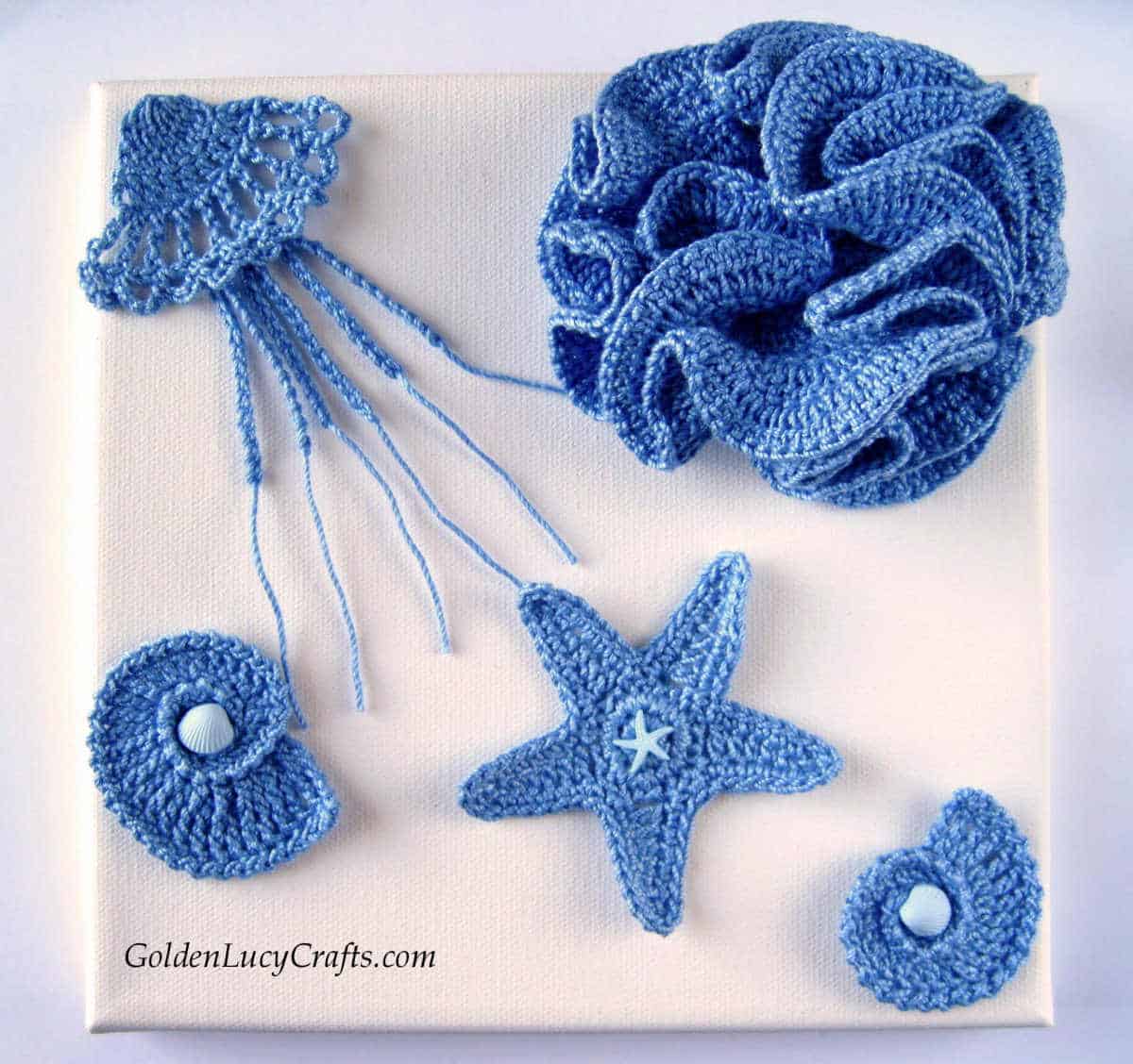 Crocheted sea motifs attached to the canvas, crochet wall art.