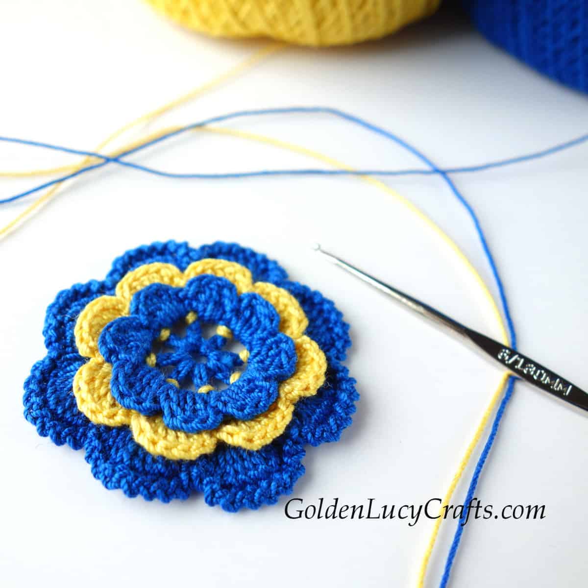 Crochet Irish rose with blue and yellow petals.