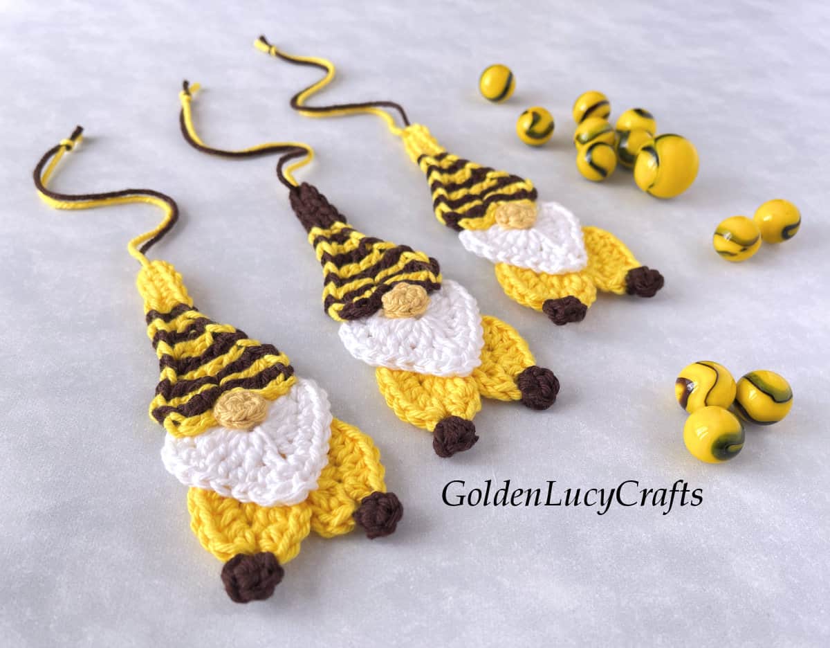 Three crocheted bee gnome ornaments.