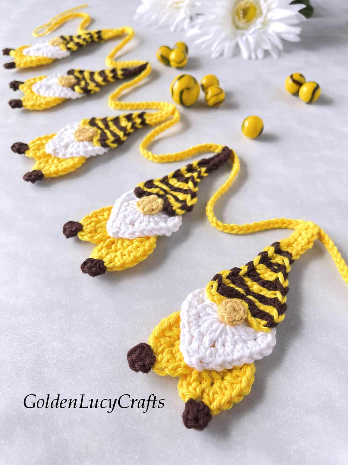 Crocheted bee gnome garland close up picture.